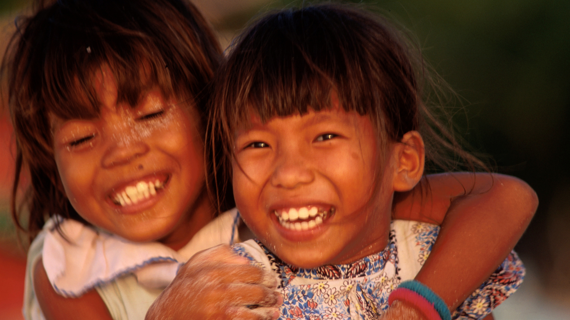 Two smiling children embracing